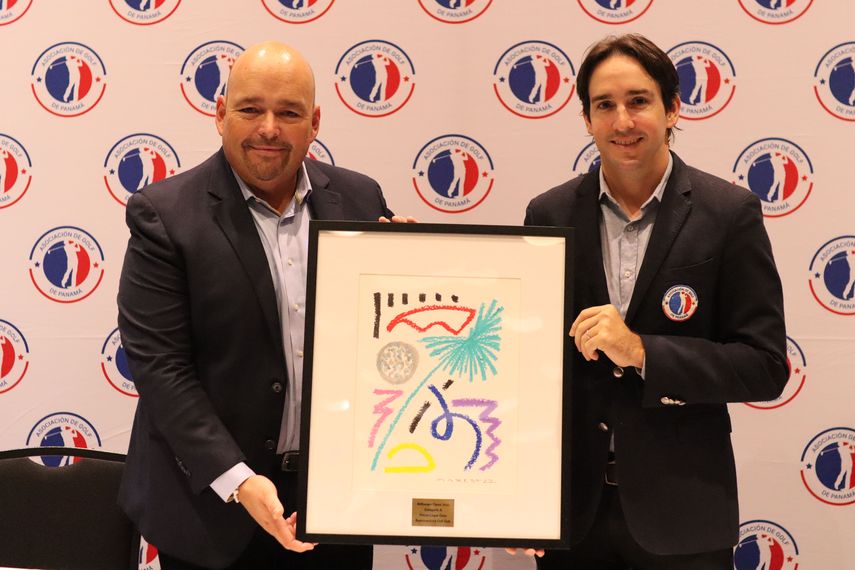 Carlos Conde (Air Europa) y Jean Pierre De Roux (presidente de APAGOLF) sostienen la obra de arte que se le otorgará al ganador del Air Europa Classic
